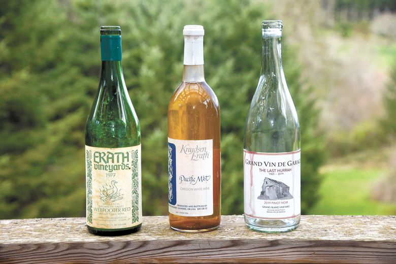 Three bottles from Kerry McDaniel Boenisch’s collection. From left: Erath Vineyards 1977 Webfooter red Oregon table wine, Knudsen Erath Pacific Mist Oregon white wine, Grand Vin de Garage 2019 Pinot Noir.##Photo courtesy of the News-Register