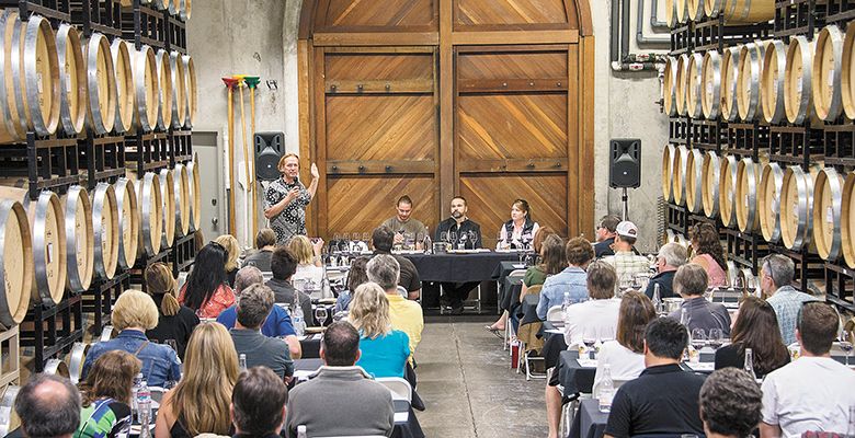 Anne Amie Winemaker Thomas Houseman speaks to a group of IPNC attendees during a field trip to the Carlton winery. Others on the panel discussed the intricacies in making Pinot Noir.##Photo by Andrea Johnson