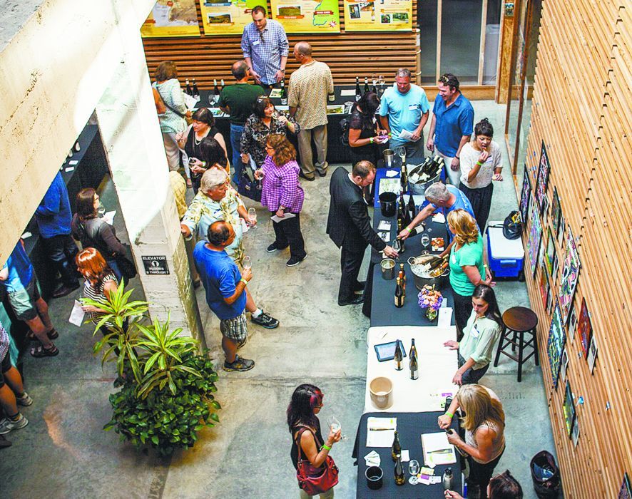 Guests at the 2014 Riesling Invasion sample some wines from the 40 producers pouring at the event held at the Olympic Mills Building in Portland. ##Photo by Jeremy Fenske