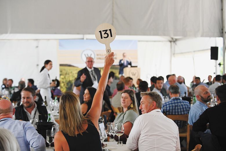 A person bidding on a lot during Willamette: The Pinot Noir Auction. ##Photo by Carolyn Wells-Kramer