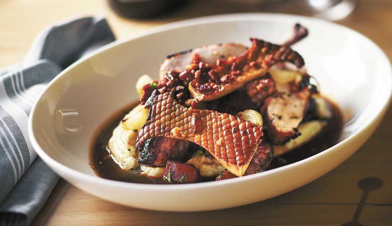 Roasted
red wine chicken
with potato
purée, roasted
mushrooms, pearl
onions, bacon and
roasted chicken
jus. ##PHOTO BY JOHN VALLS