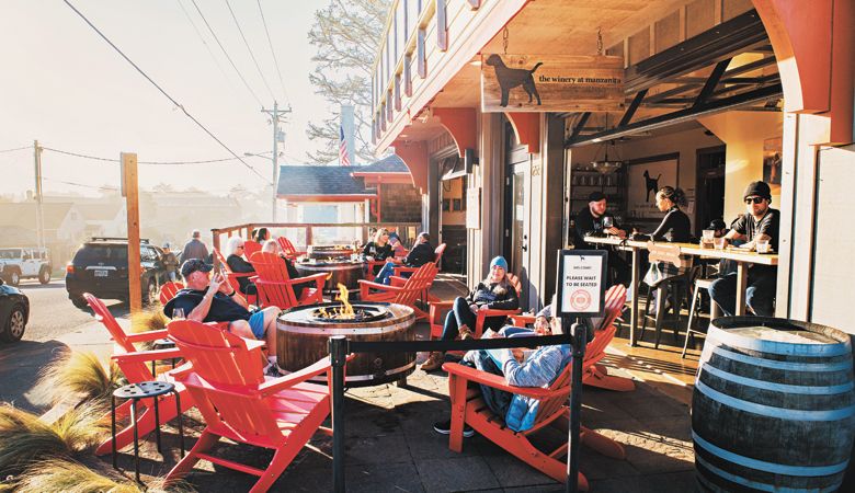 Customers relax at The Winery at Manzanita with open-air seating and a fire pit. ##Photo by Kathryn Elsesser